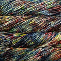 Close-up of a skein of variegated yarn with mixed colors including black, navy, blue, red, orange, yellow, and green.