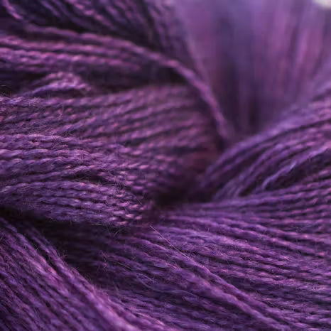 A close-up of textured purple yarn strands, showing the fine twisted fibers and rich violet color.