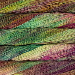 Close-up of variegated yarn strands layered horizontally, showing a mix of green, yellow, purple, and pink tones.