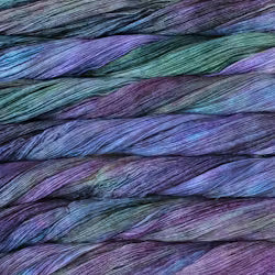Close-up of multicolored yarn strands in shades of purple, blue, and green.