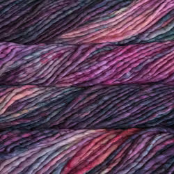 Close-up of variegated yarn skeins showing a marled blend of purple, pink, and dark charcoal tones.