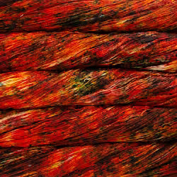 Close-up of a textured surface with red and orange colors
