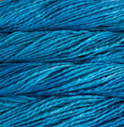 A close-up of tightly wound yarn or thread in a rich medium-to-deep teal blue color, filling the entire frame.