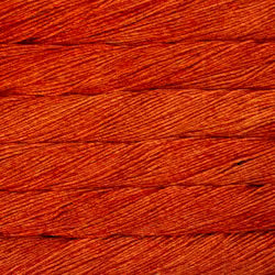 A close-up texture shot of a warm rust-orange braided cord or thread filling the entire frame.
