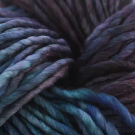 Close-up of a ball of dark blue and purple yarn