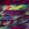 A close-up of colorful yarn strands wound together, showing a marbled mix of deep purple, magenta, green, blue, and yellow tones.