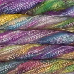 Close-up of a multicolored yarn or fiber bundle with blended purple, pink, yellow, green, blue, and orange strands.