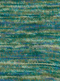 Close-up of a textured fabric with green and blue pattern