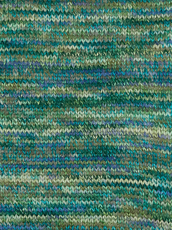 Close-up of a textured fabric with green and blue pattern