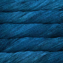 A close-up of tightly wound yarn or thread in a deep teal-blue color, filling the entire frame.