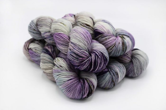 Three skeins of multicolored yarn on a white background