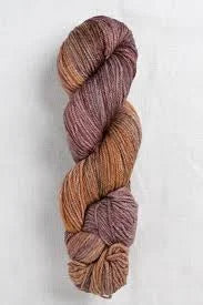 A single twisted hank of variegated yarn in earthy tones of brown, rust, and muted mauve, photographed against a light neutral background.
