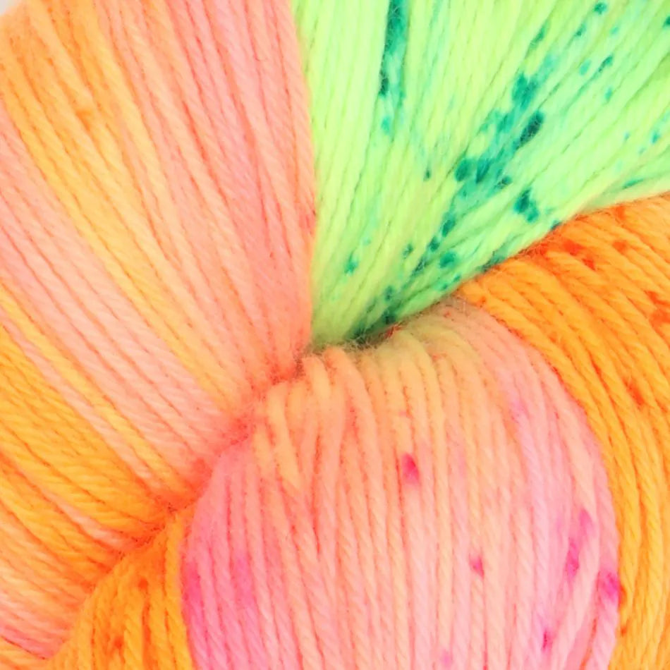Close-up of multicolored yarn with pink, green, and orange hues.
