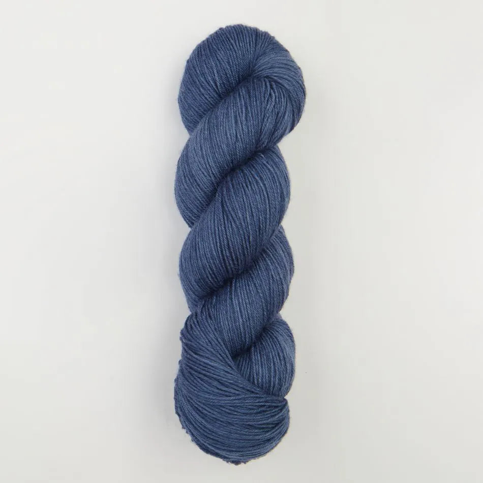 Blue skein of yarn on a light gray background