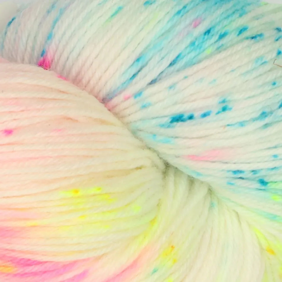 Multicolored yarn with speckles of pink, blue, and yellow.