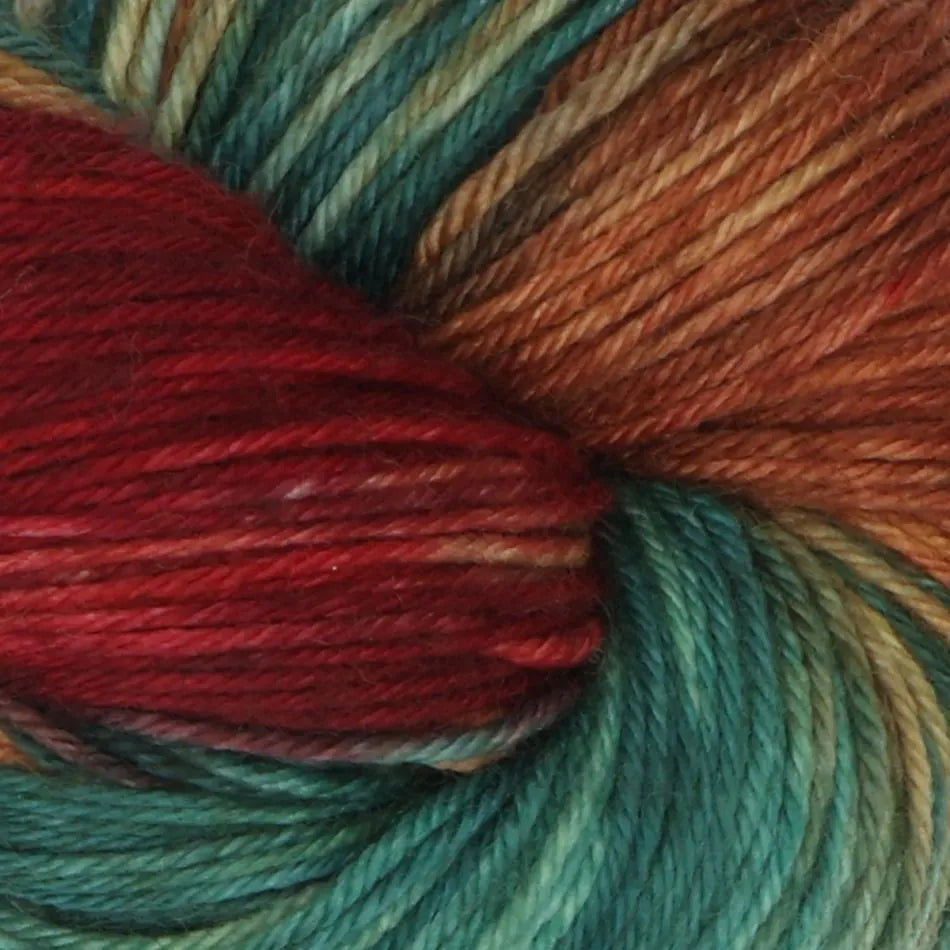 Close-up of multicolored yarn with red, green, and brown tones.